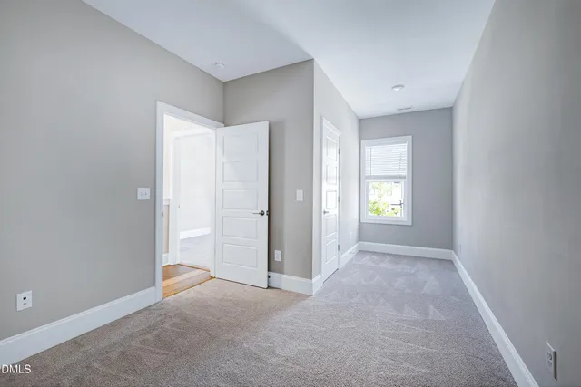 an empty room with windows and closet