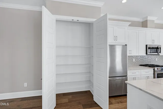 a kitchen with cabinets and stainless steel appliances