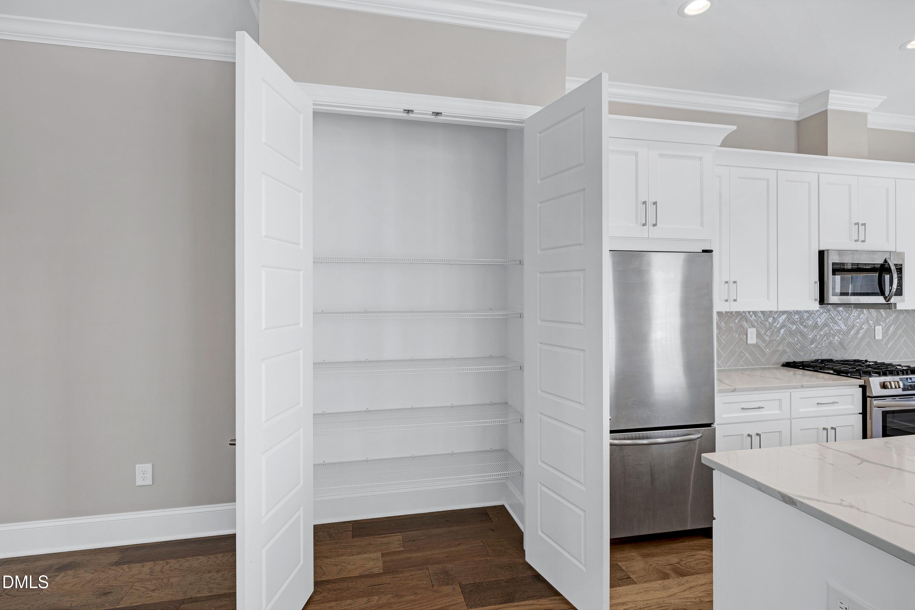 4909 Madone Drive Raleigh, NC 27606 - Photo 36 of 48 a kitchen with cabinets and stainless steel appliances