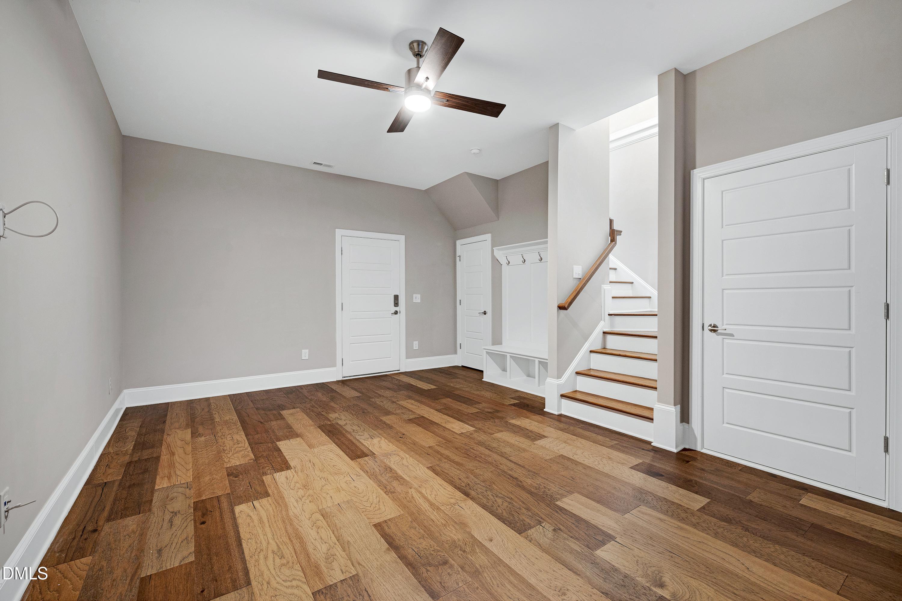 4909 Madone Drive Raleigh, NC 27606 - Photo 40 of 48 wooden floor in an empty room with a chandelier