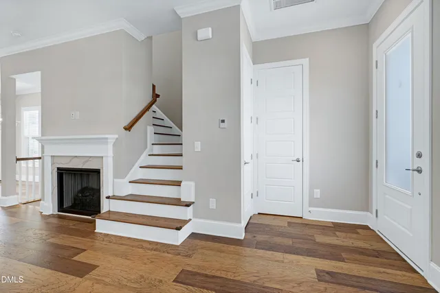 a view of entryway and hall with wooden floor