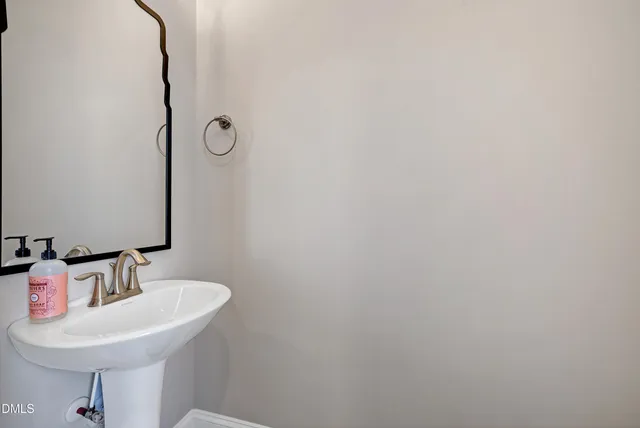 a bathroom with a sink and mirror