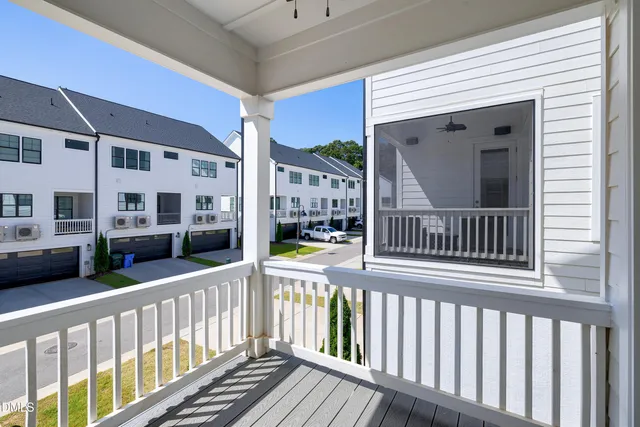 a view of a balcony with a floor to ceiling window and wooden floor