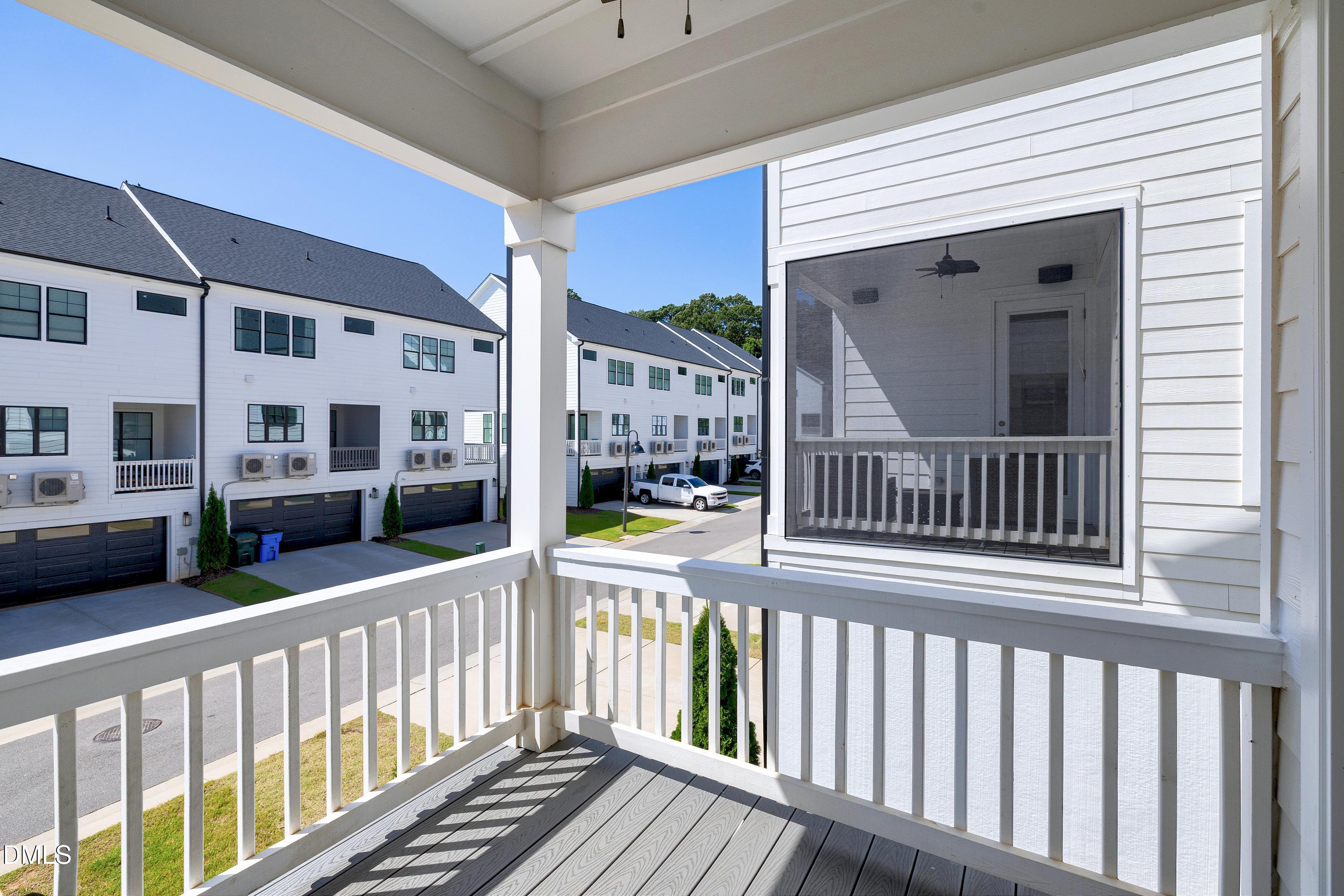 4909 Madone Drive Raleigh, NC 27606 - Photo 45 of 48 a view of a balcony with a floor to ceiling window and wooden floor