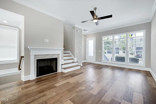 a view of empty room with wooden floor and fireplace