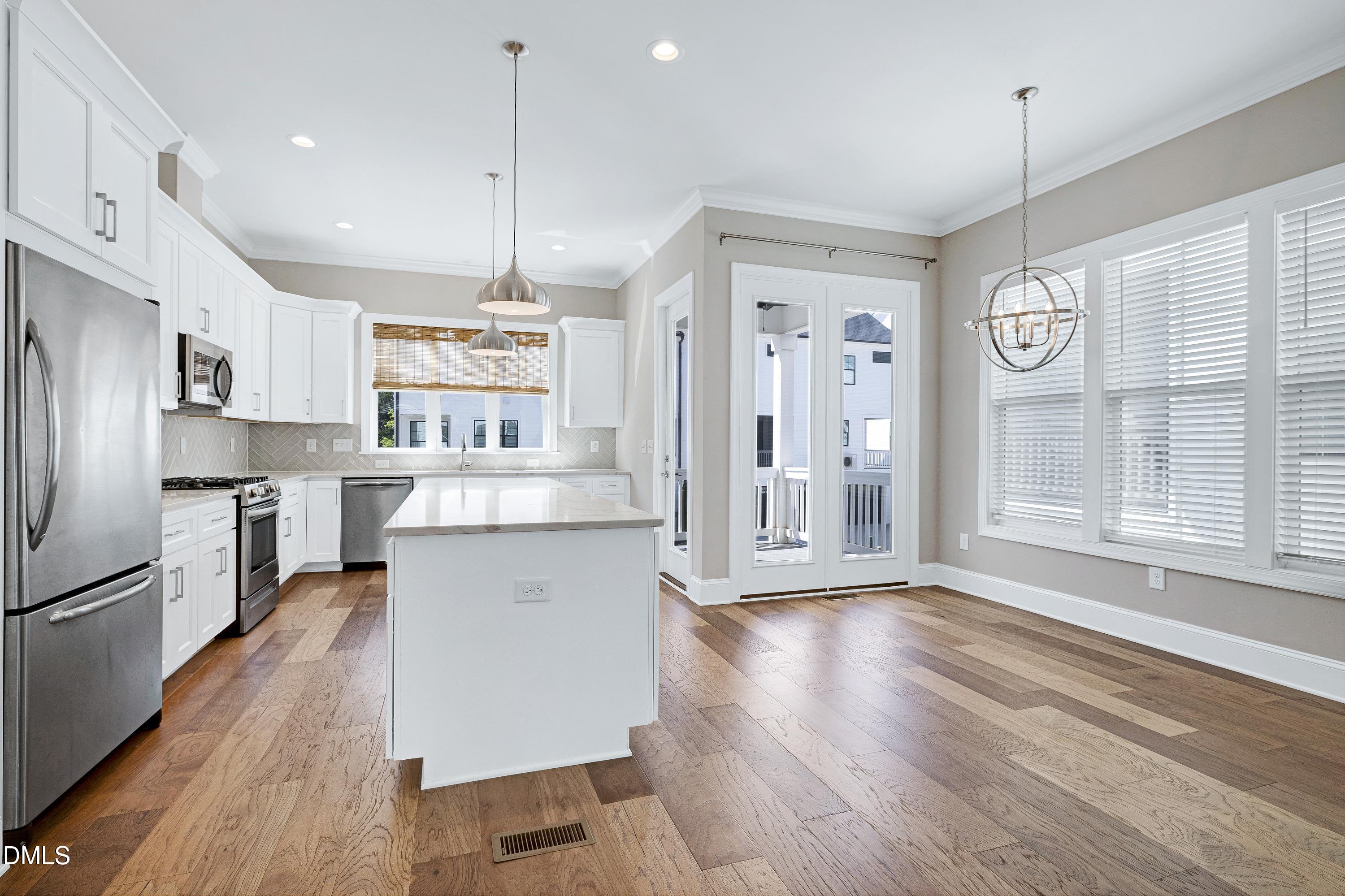 4909 Madone Drive Raleigh, NC 27606 - Photo 8 of 48 a open kitchen with stainless steel appliances granite countertop a refrigerator a stove oven a sink dishwasher and a refrigerator with wooden floor