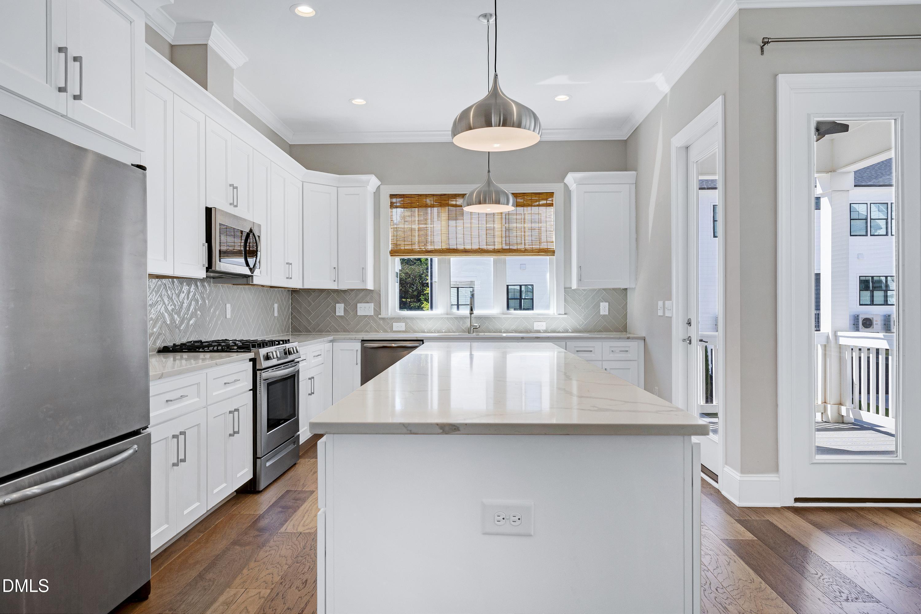 4909 Madone Drive Raleigh, NC 27606 - Photo 10 of 48 a kitchen with stainless steel appliances granite countertop a sink a stove and a refrigerator