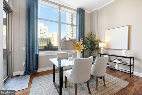 a dining room with furniture and wooden floor