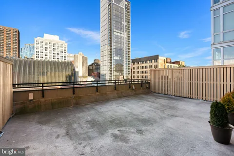 a view of a building with furniture and city view