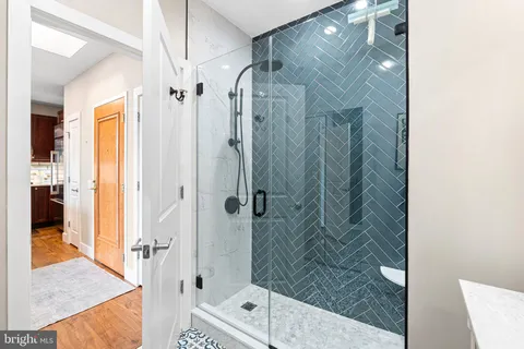 a bedroom with bed and a mirror