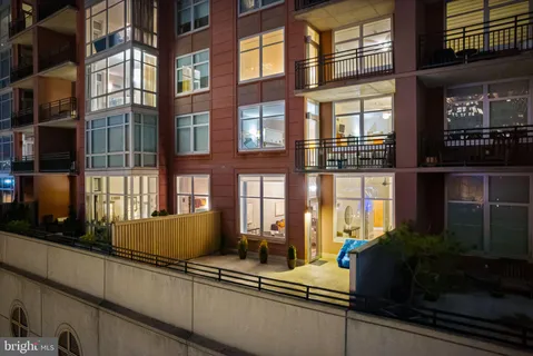 a living room with couches and a potted plant
