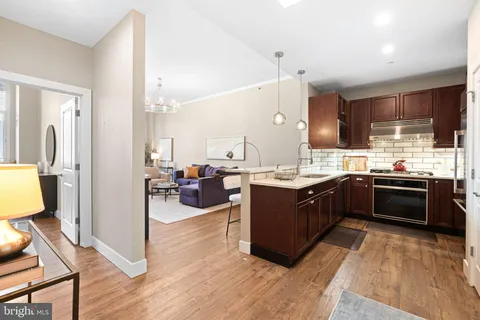 a kitchen with a sink appliances and cabinets