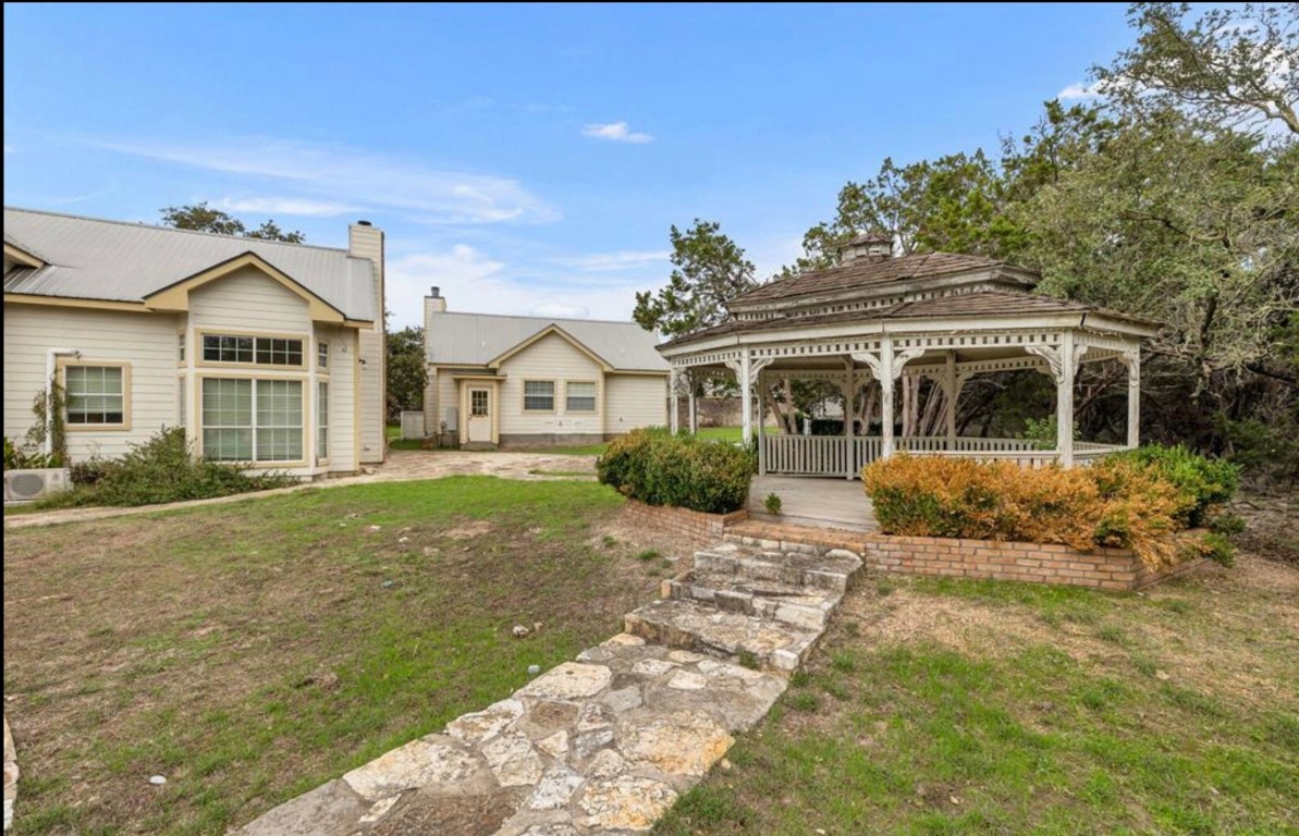 251 Circle Drive Wimberley, TX 78676 - Photo 11 of 32 a front view of a house with a garden