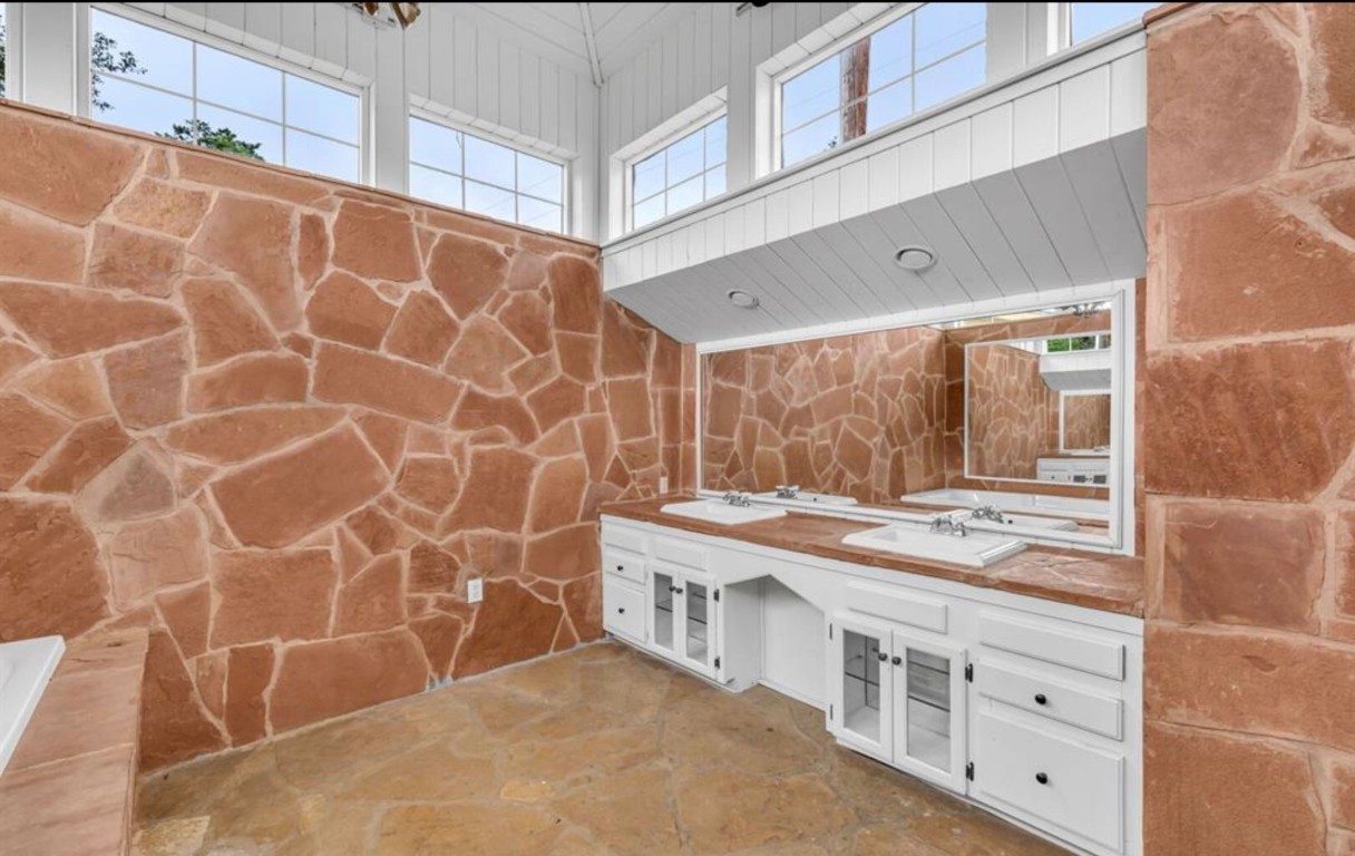 251 Circle Drive Wimberley, TX 78676 - Photo 20 of 32 a bathroom with a granite countertop sink and a mirror