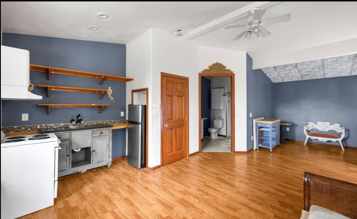 251 Circle Drive Wimberley, TX 78676 - Photo 23 of 32 a kitchen with stainless steel appliances granite countertop a refrigerator a stove and a wooden floors