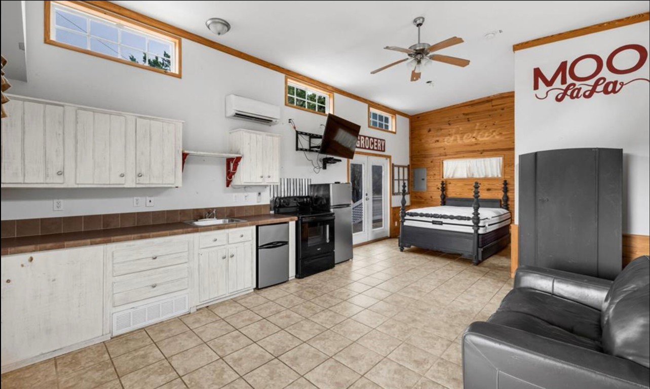 251 Circle Drive Wimberley, TX 78676 - Photo 25 of 32 a kitchen with granite countertop a sink cabinets and stainless steel appliances