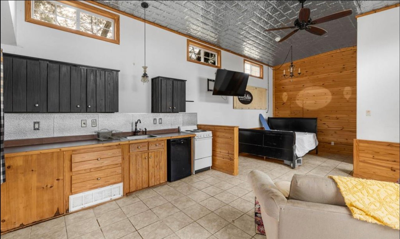 251 Circle Drive Wimberley, TX 78676 - Photo 28 of 32 a large kitchen with stainless steel appliances granite countertop a sink and a stove