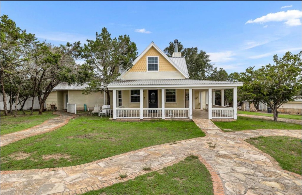 251 Circle Drive Wimberley, TX 78676 - Photo 3 of 32 a front view of a house with a yard and porch