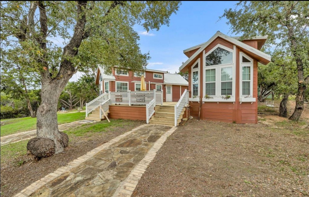 251 Circle Drive Wimberley, TX 78676 - Photo 8 of 32 a front view of a house with a yard and trees
