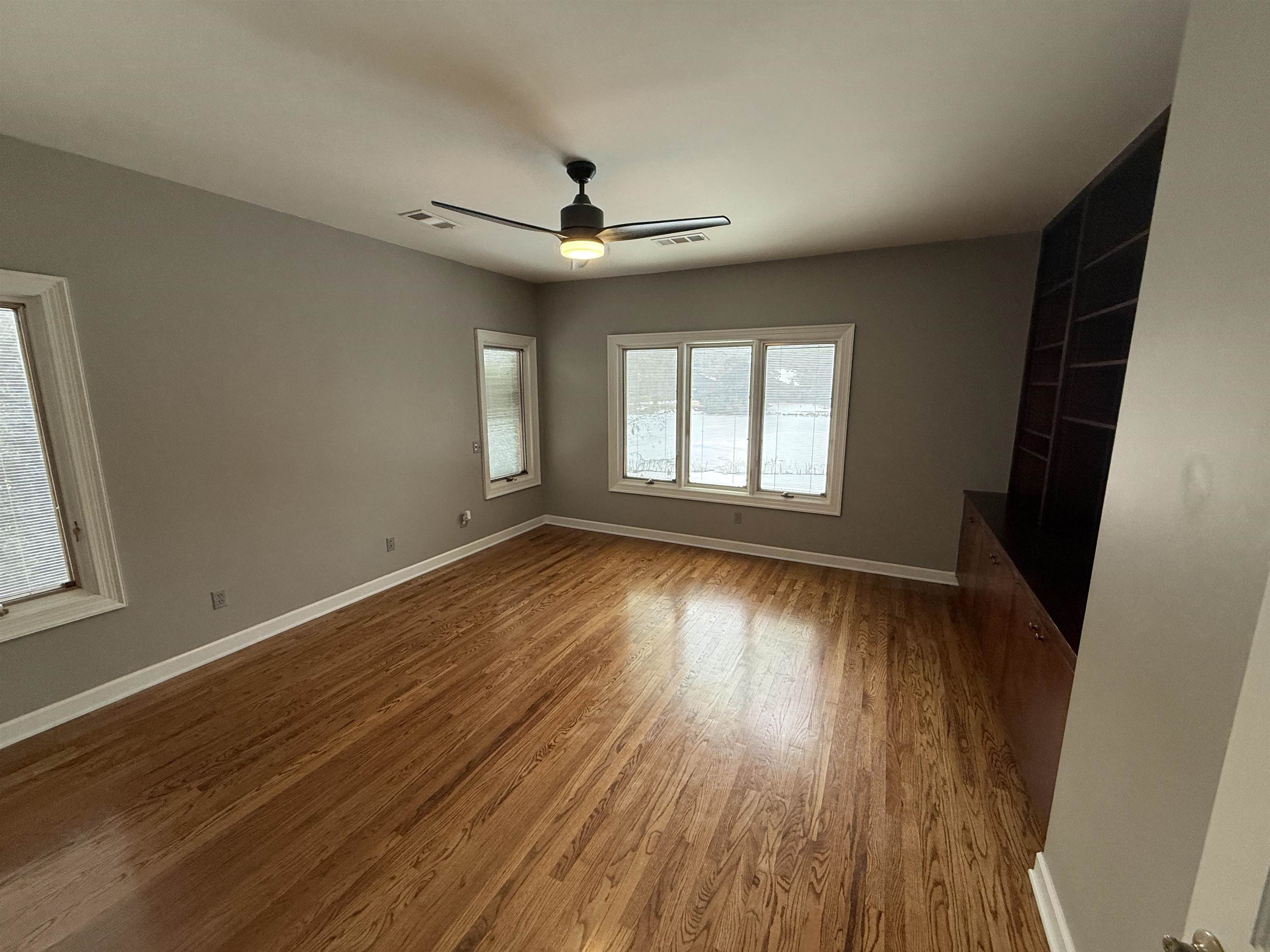 765 Sweetbrier Road Memphis, TN 38120 - Photo 12 of 33 Unfurnished living room with dark wood-type flooring and ceiling fan