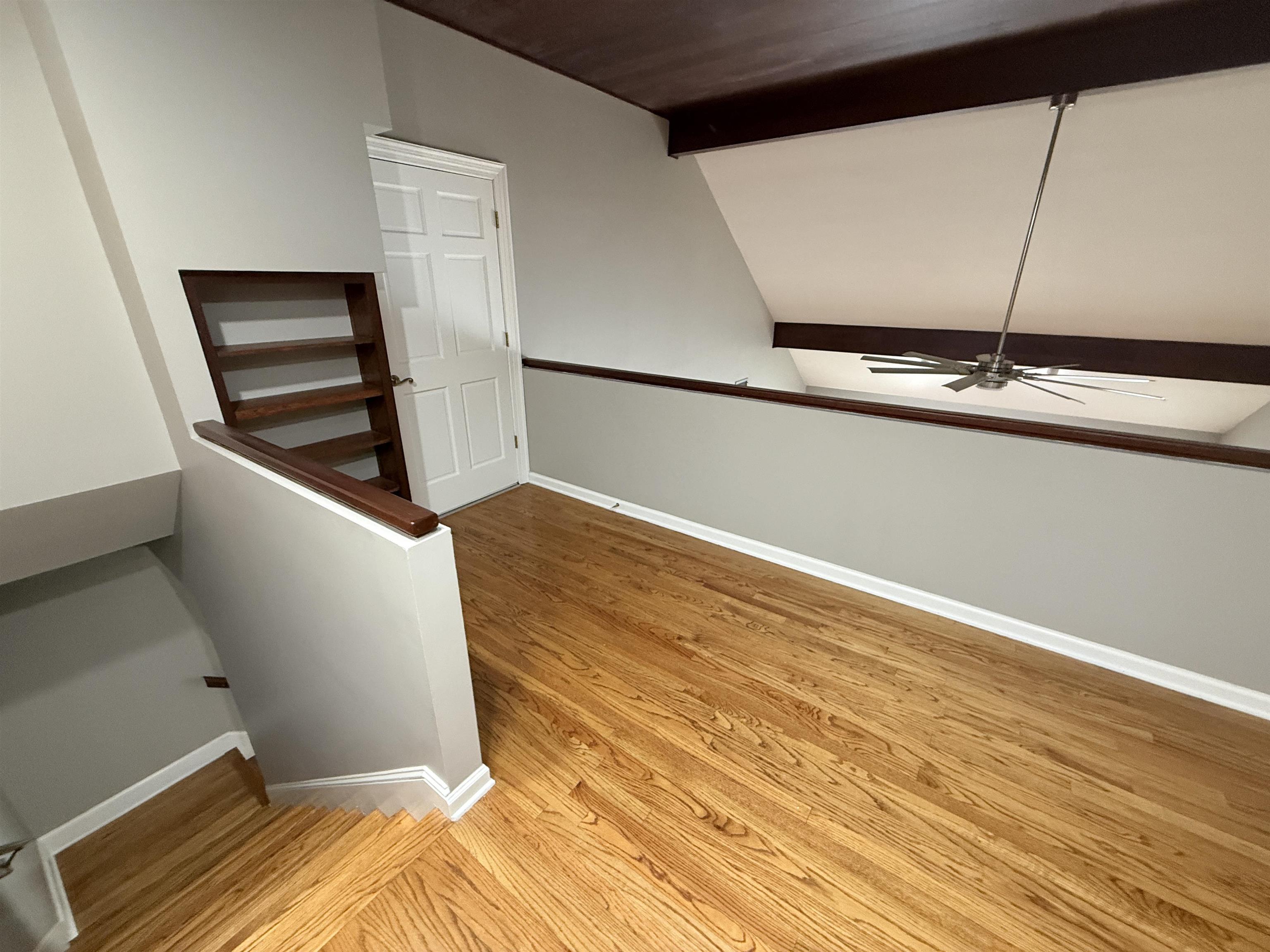 765 Sweetbrier Road Memphis, TN 38120 - Photo 19 of 33 Hallway with an upstairs landing, light wood-style floors, and vaulted ceiling with beams