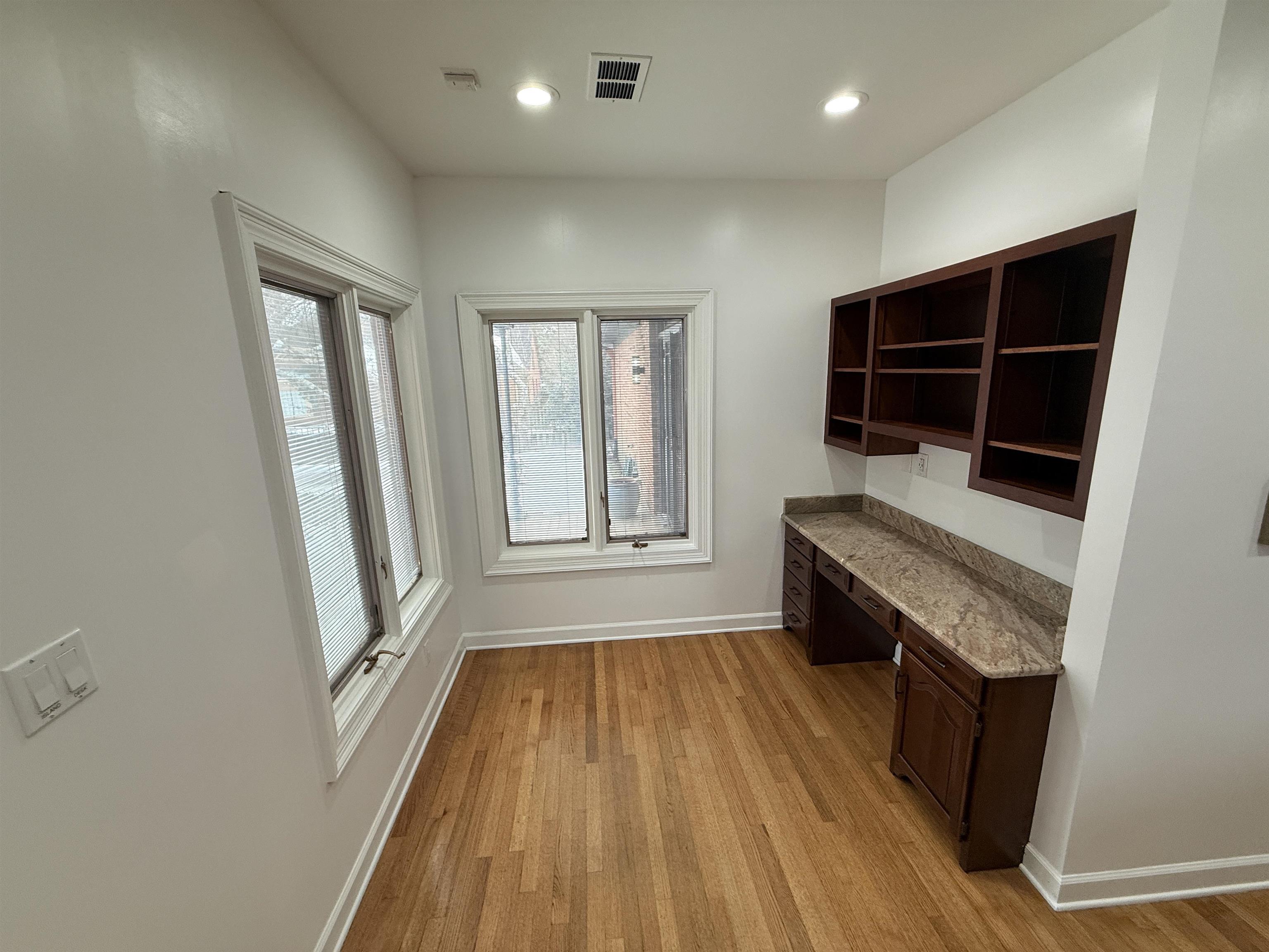 765 Sweetbrier Road Memphis, TN 38120 - Photo 4 of 33 Unfurnished office featuring built in desk, light wood finished floors, and recessed lighting