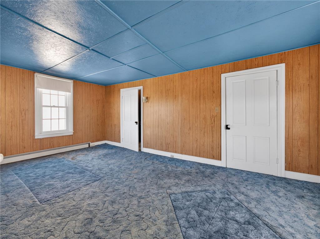 15845 Kutztown Road Mertztown, PA 19539 - Photo 11 of 24 Well-lit interior space features unique blue carpeting, paneled walls, and a window.