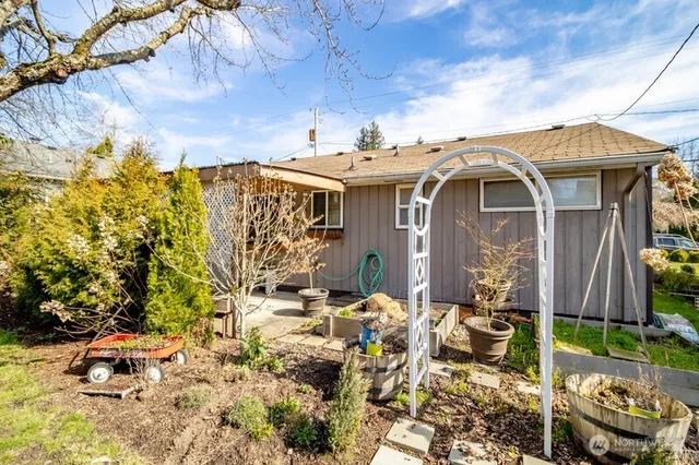a view of a patio with table and chairs and potted plants