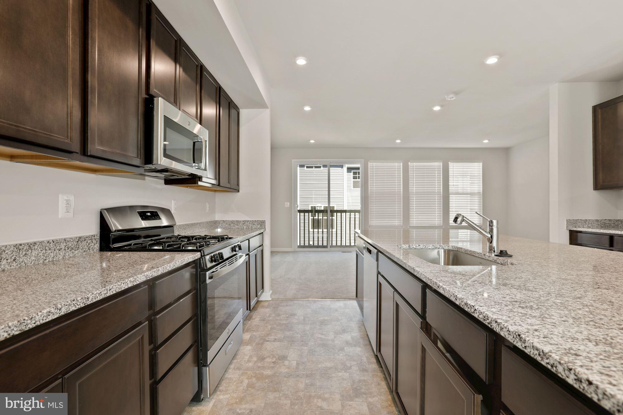 3970 Shire Meadow Lane Triangle, VA 22172 - Photo 11 of 52 a kitchen with granite countertop stainless steel appliances and sink