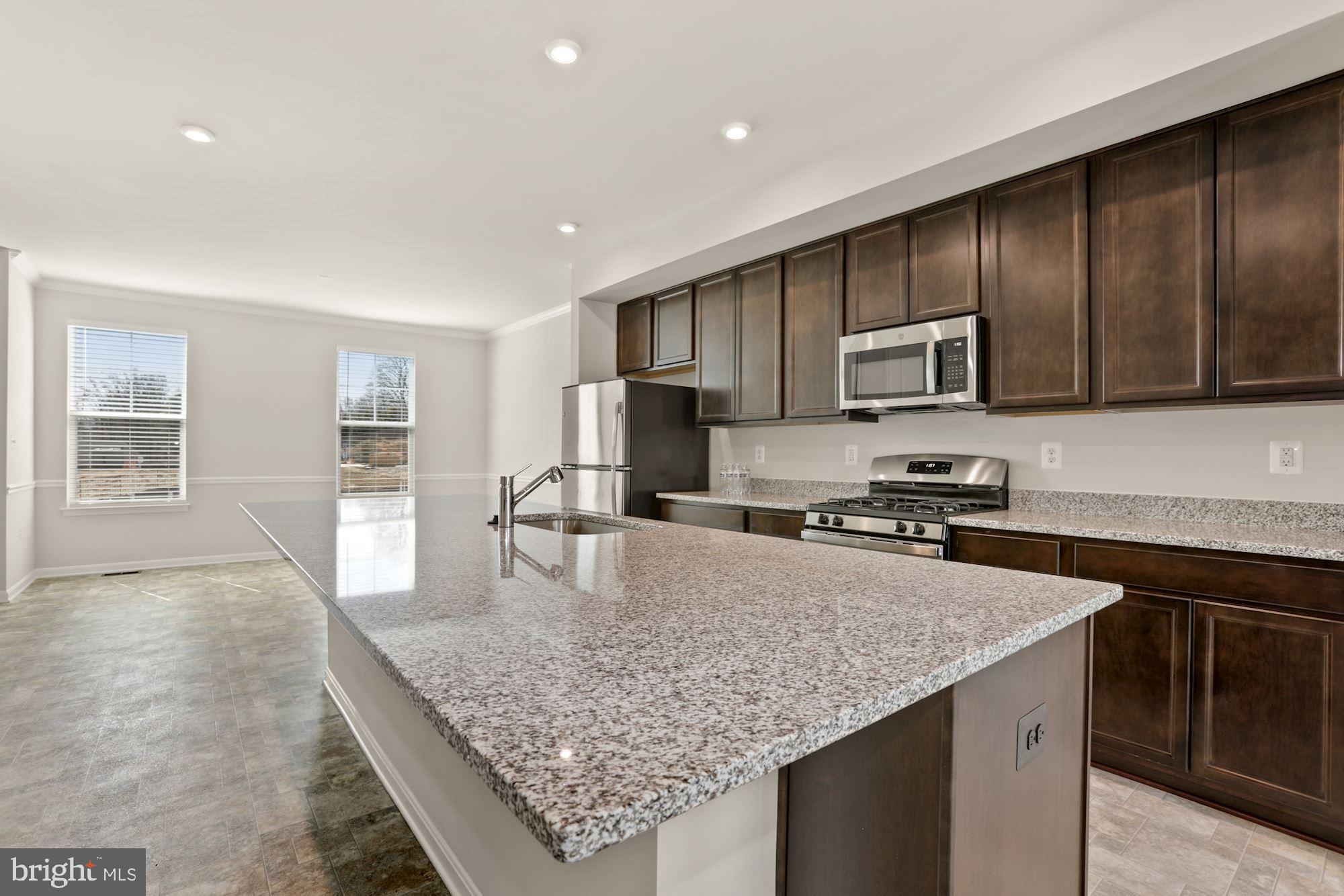 3970 Shire Meadow Lane Triangle, VA 22172 - Photo 13 of 52 a kitchen with stainless steel appliances granite countertop a sink dishwasher stove top oven and refrigerator