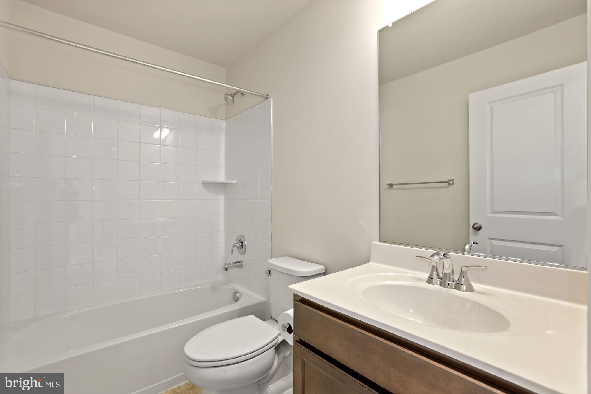 3970 Shire Meadow Lane Triangle, VA 22172 - Photo 44 of 52 a bathroom with a sink toilet and shower