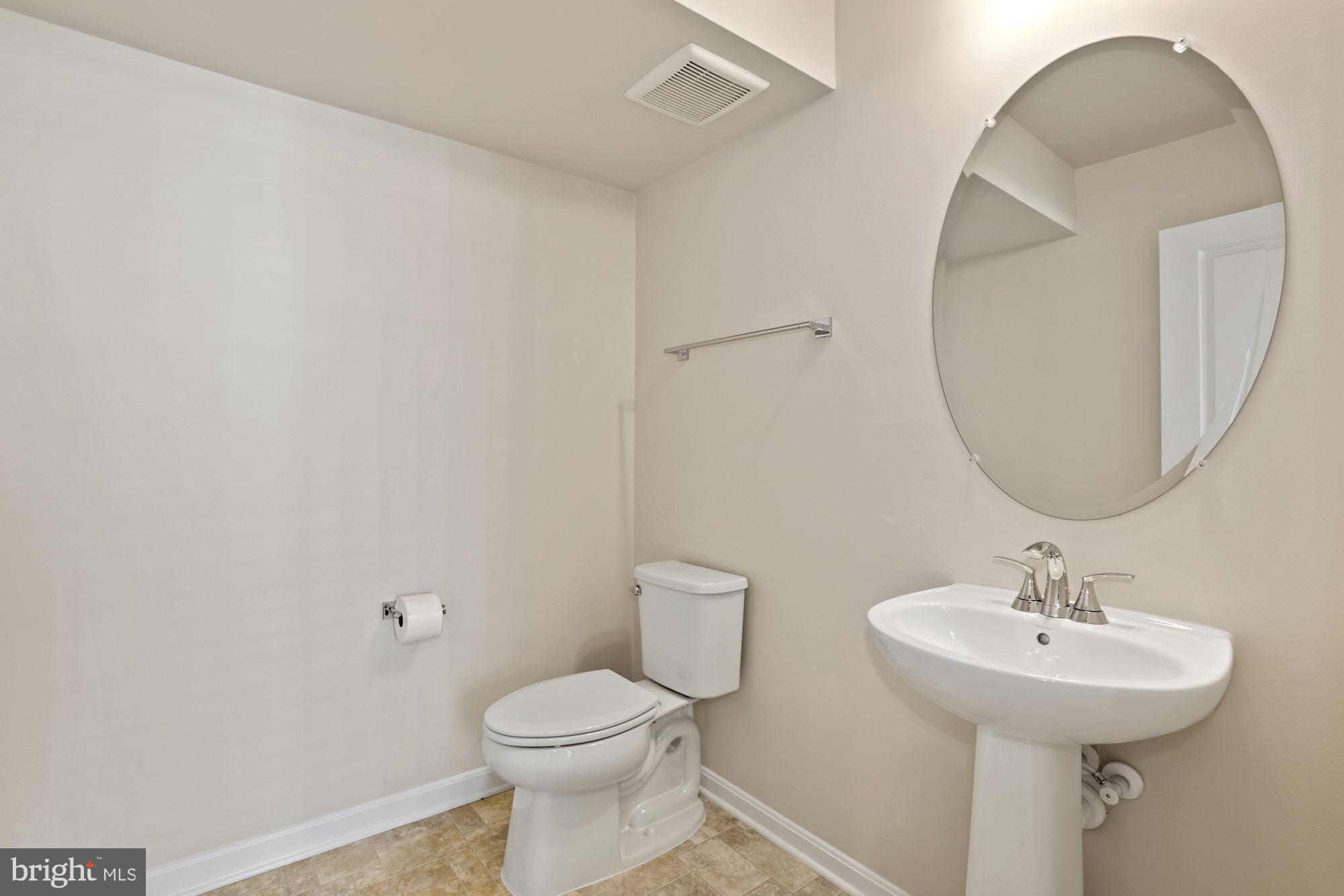 3970 Shire Meadow Lane Triangle, VA 22172 - Photo 50 of 52 a bathroom with a toilet sink and mirror