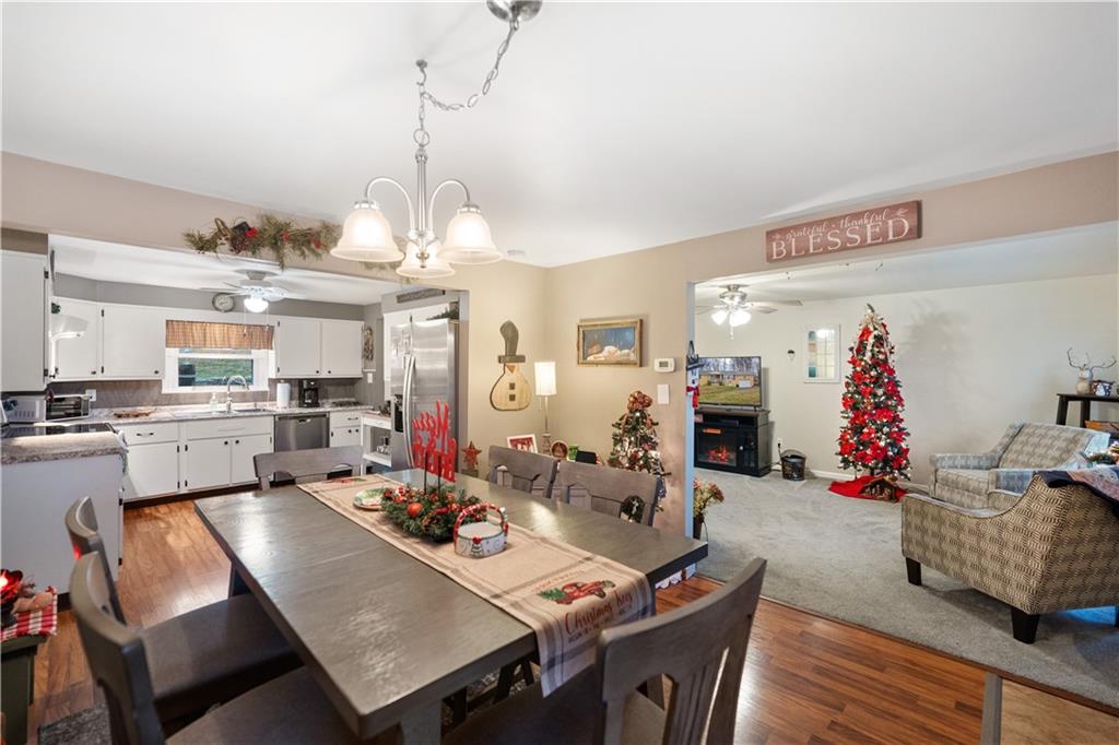 355 Middletown Road New Stanton, PA 15672 - Photo 2 of 21 a view of a dining room and livingroom with furniture wooden floor a rug a painting and a chandelier