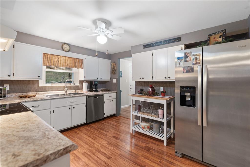 355 Middletown Road New Stanton, PA 15672 - Photo 5 of 21 a kitchen with a refrigerator and white cabinets