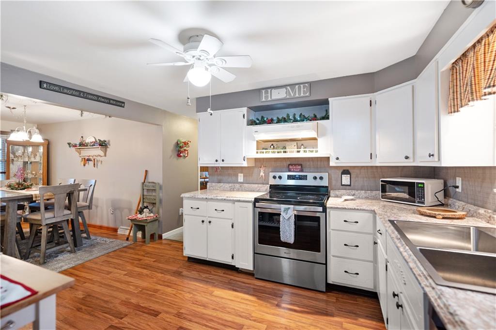 355 Middletown Road New Stanton, PA 15672 - Photo 7 of 21 a kitchen with stove cabinets and wooden floor