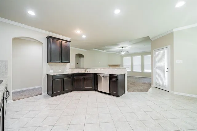 a kitchen with stainless steel appliances granite countertop a sink stove microwave and refrigerator