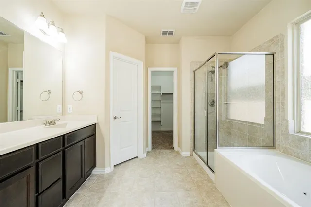 a bathroom with a bathtub and a shower