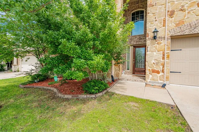 a yellow building with trees in front of it