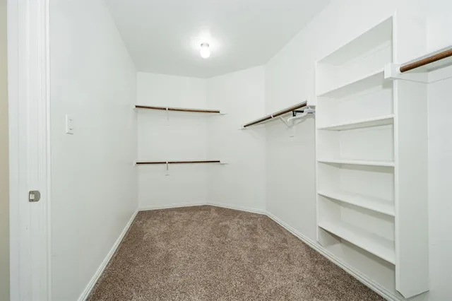 a spacious bedroom with a bed and window