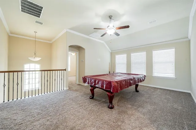 a spacious bedroom with a bed and a chandelier