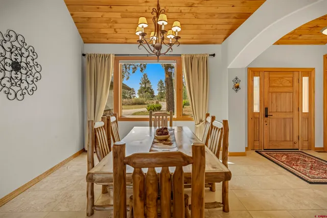 a view of a dining room with furniture window and outside view
