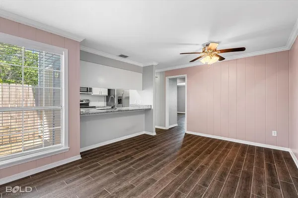 a view of kitchen with wooden floor and electronic appliances