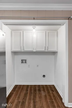 a view of a room with wooden floor and cabinets