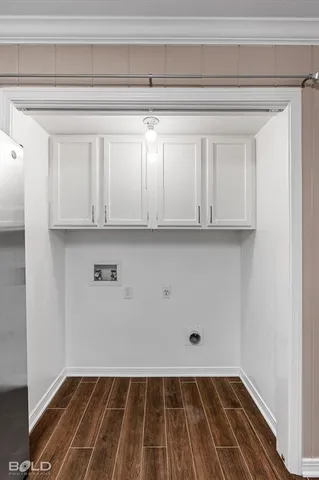a view of a room with wooden floor and cabinets