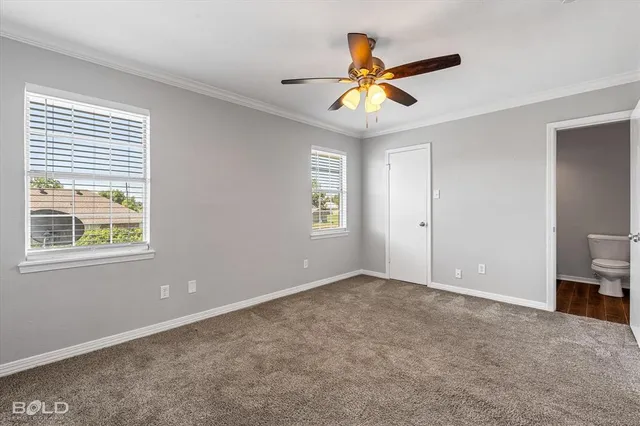 a view of a livingroom with a ceiling fan and window