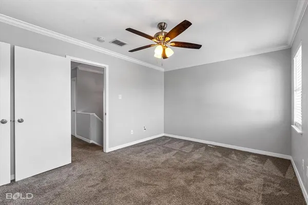 a view of a ceiling fan and a window