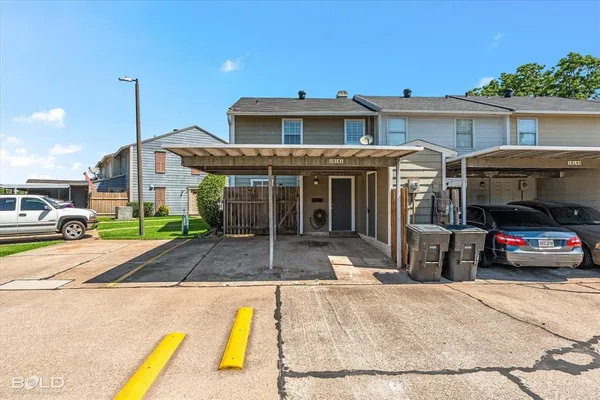 a view of a car park in front of house