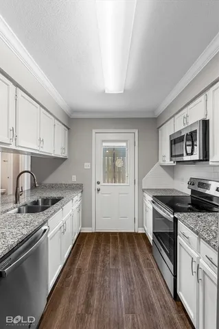 a kitchen with granite countertop stainless steel appliances and wooden cabinets
