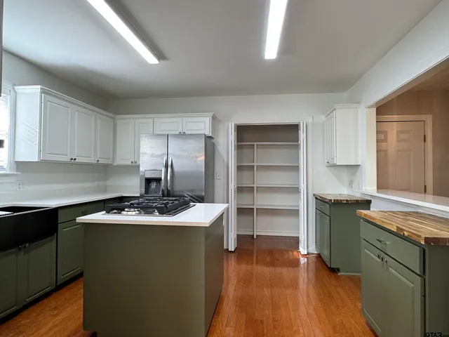a kitchen with a sink stove and cabinets