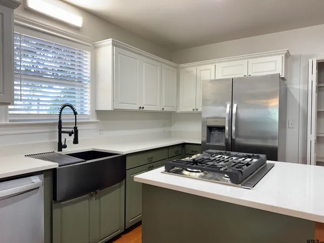 a kitchen with a stove a sink and a refrigerator